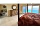 Large bedroom featuring a four-poster bed and an ocean view at 880 Mandalay Ave # C1103, Clearwater Beach, FL 33767