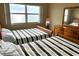 Bedroom featuring two twin beds and a window overlooking the ocean with furnishings at 880 Mandalay Ave # C1103, Clearwater Beach, FL 33767