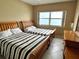Bedroom featuring two twin beds and a window overlooking the ocean at 880 Mandalay Ave # C1103, Clearwater Beach, FL 33767