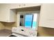 Kitchen view from stove through window to ocean view in modern, bright condo at 880 Mandalay Ave # C1103, Clearwater Beach, FL 33767