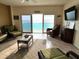 Bright and inviting living room with amazing ocean views and comfortable wicker furniture at 880 Mandalay Ave # C1103, Clearwater Beach, FL 33767