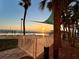 Beautiful pool area with palm trees and a sunset view at 880 Mandalay Ave # C1103, Clearwater Beach, FL 33767