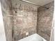 Walk in shower featuring marble style tiles and chrome fixtures at 880 Mandalay Ave # C1103, Clearwater Beach, FL 33767
