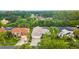 Aerial shot of the house showcases the home's proximity to lush landscaping and neighborhood amenities at 9402 Woodbay Dr, Tampa, FL 33626