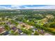 Expansive aerial view of a residential neighborhood featuring lush greenery and beautiful homes with private pools at 9402 Woodbay Dr, Tampa, FL 33626
