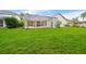 Expansive backyard with a screened-in lanai and a well-manicured lawn, ideal for outdoor gatherings at 9402 Woodbay Dr, Tampa, FL 33626