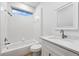 Bright bathroom featuring a tub, shower, and a modern sink with marble countertops and an all white design at 9402 Woodbay Dr, Tampa, FL 33626