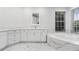 Modern bathroom with a double vanity, soaking tub, marble accents, and a large window for natural light at 9402 Woodbay Dr, Tampa, FL 33626