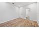 Bedroom with hard surface flooring, two entry doors, and access to an en-suite bathroom at 9402 Woodbay Dr, Tampa, FL 33626