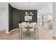 Elegant dining area with a modern light fixture and a view into the well-appointed kitchen at 9402 Woodbay Dr, Tampa, FL 33626