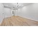 Empty room features wood floors, neutral walls, modern lighting, and ample space for customization at 9402 Woodbay Dr, Tampa, FL 33626