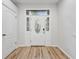Bright foyer with a decorative front door and elegant wood floors, offering a warm welcome at 9402 Woodbay Dr, Tampa, FL 33626