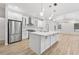 Bright kitchen features a large island with quartz countertops and stainless steel appliances at 9402 Woodbay Dr, Tampa, FL 33626