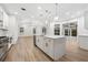 Open concept kitchen with a large island, quartz countertops, stainless appliances, and wood floors at 9402 Woodbay Dr, Tampa, FL 33626