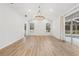 Bright living room featuring wood floors, large windows, modern lighting, and view of the pool area at 9402 Woodbay Dr, Tampa, FL 33626