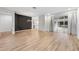 Open-concept living room featuring hardwood floors and sliding glass doors to an outdoor living area at 9402 Woodbay Dr, Tampa, FL 33626