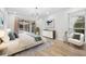 Inviting main bedroom with wood floors, large window, and slider to the pool area, enhancing natural light at 9402 Woodbay Dr, Tampa, FL 33626
