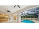 Backyard views of the screened-in pool and patio, seamlessly connected to the home's interior at 9402 Woodbay Dr, Tampa, FL 33626
