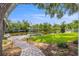 Landscaped backyard with a paved walkway leading to a private dock and boat lift on the canal at 715 45Th Ne Ave, St Petersburg, FL 33703