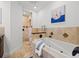 Modern bathroom with a soaking tub, separate shower, and travertine tile at 715 45Th Ne Ave, St Petersburg, FL 33703