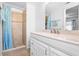 Bright bathroom featuring tiled shower, a large vanity, and ample storage space for an organized space at 10213 Westport Ct, Tampa, FL 33615