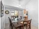Well-lit dining room featuring a classic chandelier, tile flooring, and easy access to the kitchen for convenient serving at 10213 Westport Ct, Tampa, FL 33615