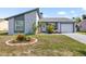 Charming home with unique stone facade, well-manicured lawn, and vibrant flowerbeds offering great curb appeal at 10213 Westport Ct, Tampa, FL 33615