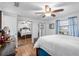 Bright main bedroom with wood-look floors, a ceiling fan, and large closet at 10213 Westport Ct, Tampa, FL 33615