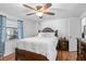 Comfortable main bedroom with natural light from a window and a ceiling fan at 10213 Westport Ct, Tampa, FL 33615