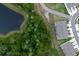 Aerial of townhomes next to a pond and walking path surrounded by lush greenery at 11054 Crescent Deer Dr, Land O Lakes, FL 34638