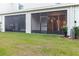 Expansive backyard featuring an enclosed patio and well-maintained lawn at 11054 Crescent Deer Dr, Land O Lakes, FL 34638