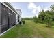 Spacious backyard features a screened lanai and green lawn at 11054 Crescent Deer Dr, Land O Lakes, FL 34638