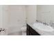 Bright bathroom featuring modern fixtures, a shower-tub combo, and a stylish granite vanity at 11054 Crescent Deer Dr, Land O Lakes, FL 34638