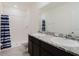 Bathroom showcasing a double sink vanity with granite countertops and a walk-in shower at 11054 Crescent Deer Dr, Land O Lakes, FL 34638
