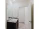Bathroom with modern vanity, granite countertop, sink and an adjacent doorway at 11054 Crescent Deer Dr, Land O Lakes, FL 34638