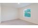 Neutral bedroom featuring a bright window at 11054 Crescent Deer Dr, Land O Lakes, FL 34638