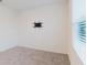 Bright, carpeted bedroom with window and TV mount at 11054 Crescent Deer Dr, Land O Lakes, FL 34638