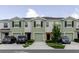 View of multiple modern townhomes, each with a driveway and well-kept front yard landscaping at 11054 Crescent Deer Dr, Land O Lakes, FL 34638