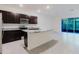 Modern kitchen with granite countertops, stainless steel appliances, and a center island at 11054 Crescent Deer Dr, Land O Lakes, FL 34638