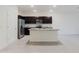 Modern kitchen with dark cabinets, stainless steel appliances, and granite countertops at 11054 Crescent Deer Dr, Land O Lakes, FL 34638