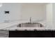 Close up on kitchen island with stainless steel sink and granite countertop at 11054 Crescent Deer Dr, Land O Lakes, FL 34638