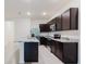 Kitchen with stainless steel appliances, dark cabinets, and granite countertops at 11054 Crescent Deer Dr, Land O Lakes, FL 34638