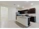 Bright kitchen features dark cabinetry, stainless steel appliances, and gray tile flooring at 11054 Crescent Deer Dr, Land O Lakes, FL 34638