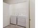 Laundry room showcasing a side-by-side washer and dryer with overhead storage at 11054 Crescent Deer Dr, Land O Lakes, FL 34638