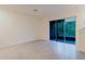Bright, airy living room with tile flooring and sliding glass doors to the outside at 11054 Crescent Deer Dr, Land O Lakes, FL 34638