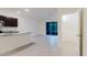 Open living room with access to kitchen and screened porch at 11054 Crescent Deer Dr, Land O Lakes, FL 34638