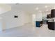 Living room with gray tile flooring leading to the kitchen area at 11054 Crescent Deer Dr, Land O Lakes, FL 34638