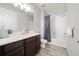 Bathroom features a single sink vanity and a shower-tub combination with a grey shower curtain at 11719 Tetrafin Dr, Riverview, FL 33579