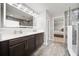 Beautiful bathroom with double sinks, a large mirror, and a walk-in shower with elegant tile work at 11719 Tetrafin Dr, Riverview, FL 33579