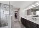 An elegant bathroom featuring a double vanity and a spacious, glass-enclosed shower with marble tile at 11719 Tetrafin Dr, Riverview, FL 33579